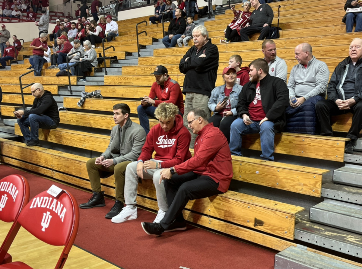 During his recruiting visit, Indiana quarterback Tayven Jackson talks with head coach Tom Allen (right) and offensive coordinator Walt Bell (left) before the Indiana basketball game against Wisconsin on Jan. 14 at Simon Skjodt Assembly Hall in Bloomington, Ind. 