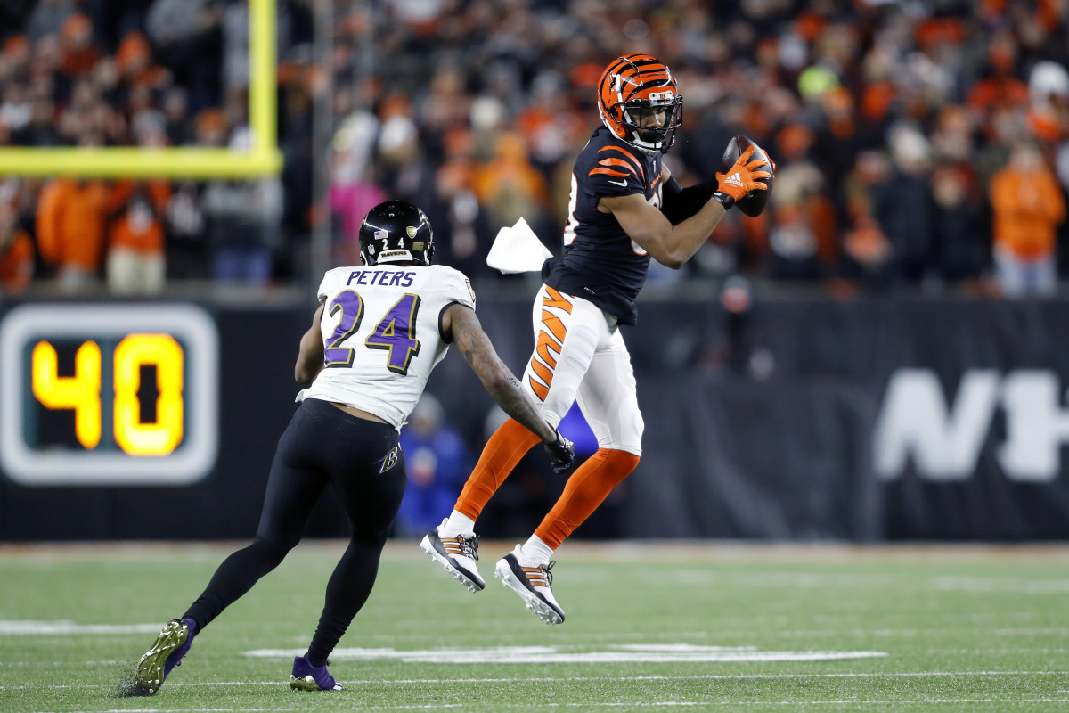 Jan 15, 2023; Cincinnati, Ohio, USA; Cincinnati Bengals wide receiver Tyler Boyd (83) makes a catch while defended by Baltimore Ravens cornerback Marcus Peters (24) during the second half in a wild card game at Paycor Stadium. Mandatory Credit: Joseph Maiorana-USA TODAY Sports