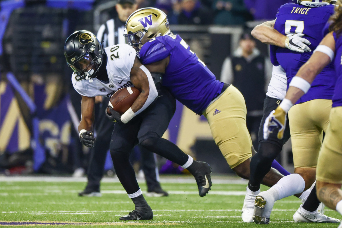 Seattle, Washington, USA; Washington Huskies defensive lineman Jeremiah Martin (3) tackles Colorado Buffaloes running back Deion Smith (20) during the second quarter at Alaska Airlines Field at Husky Stadium.