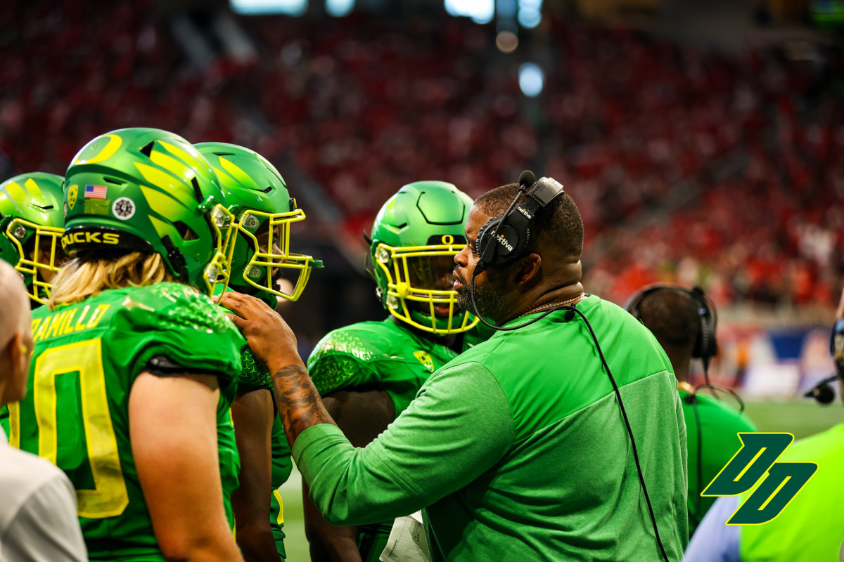 Oregon offensive line coach Adrian Klemm with Steven Jones during the 2022 Chick-Fil-A Kickoff game vs. the Georgia Bulldogs in Atlanta.