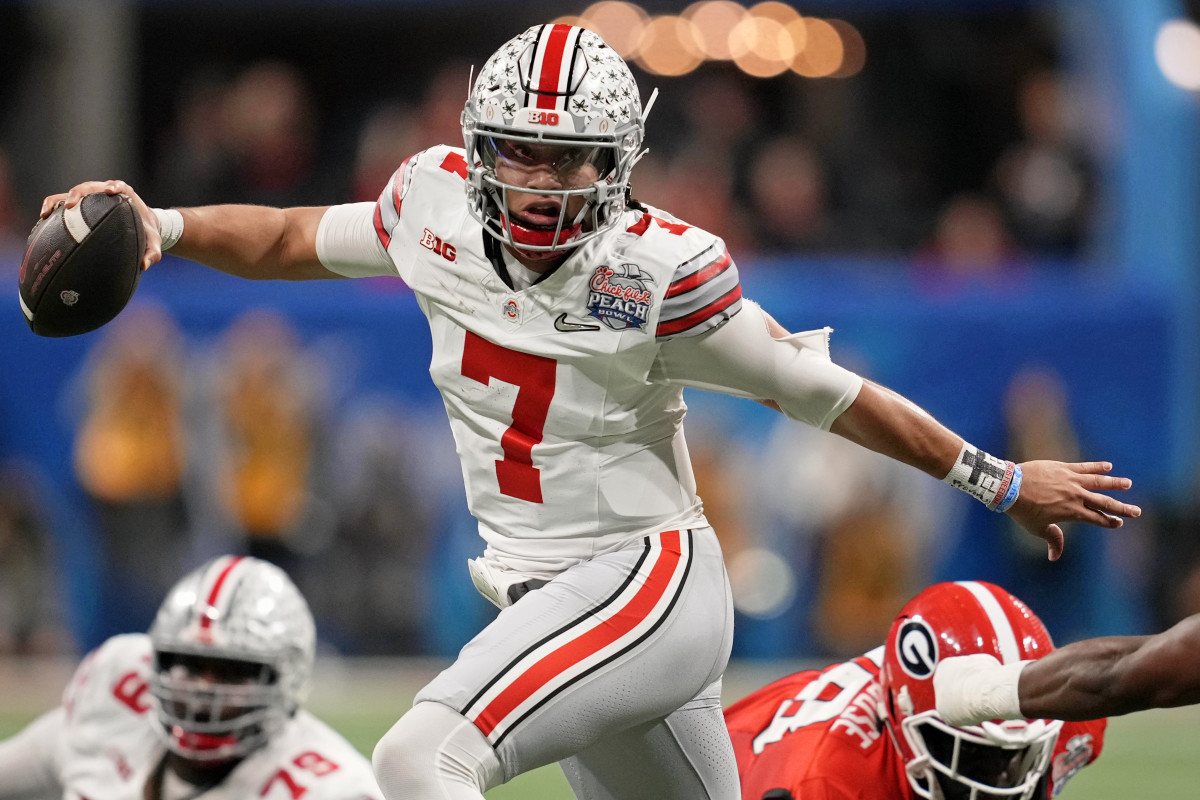 Dec 31, 2022; Atlanta, Georgia, USA; Ohio State Buckeyes quarterback C.J. Stroud (7) evades pressure from the Georgia Bulldogs during the second quarter of the 2022 Peach Bowl at Mercedes-Benz Stadium. Mandatory Credit: Dale Zanine-USA TODAY Sports