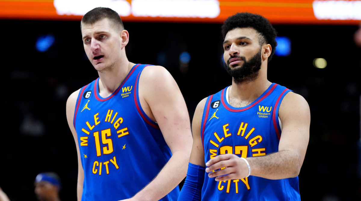 Nuggets center Nikola Jokic and guard Jamal Murray walk off the floor together
