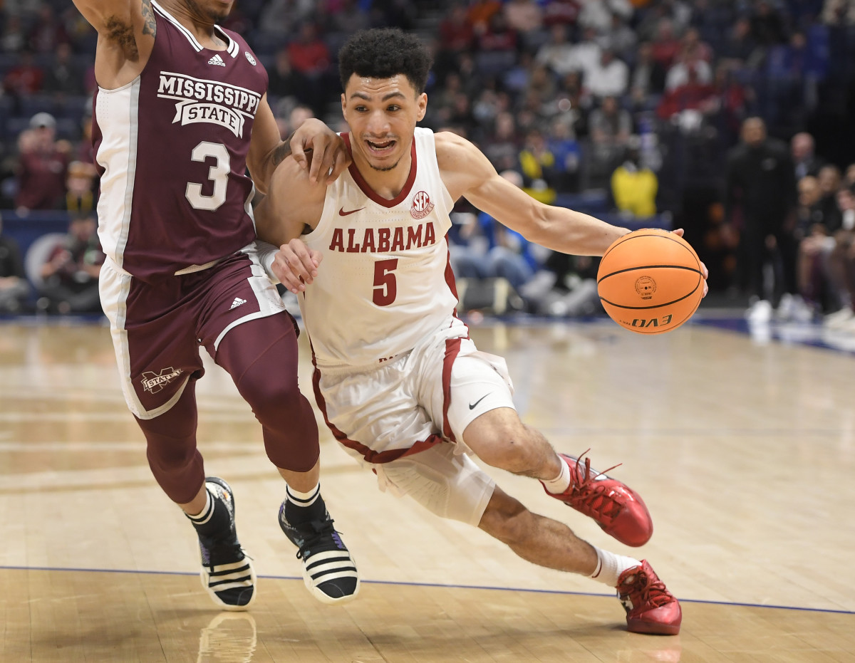 Alabama Crimson Tide guard Jahvon Quinerly (5) drives past Mississippi State Bulldogs guard Shakeel Moore (3) during the second half at Bridgestone Arena.