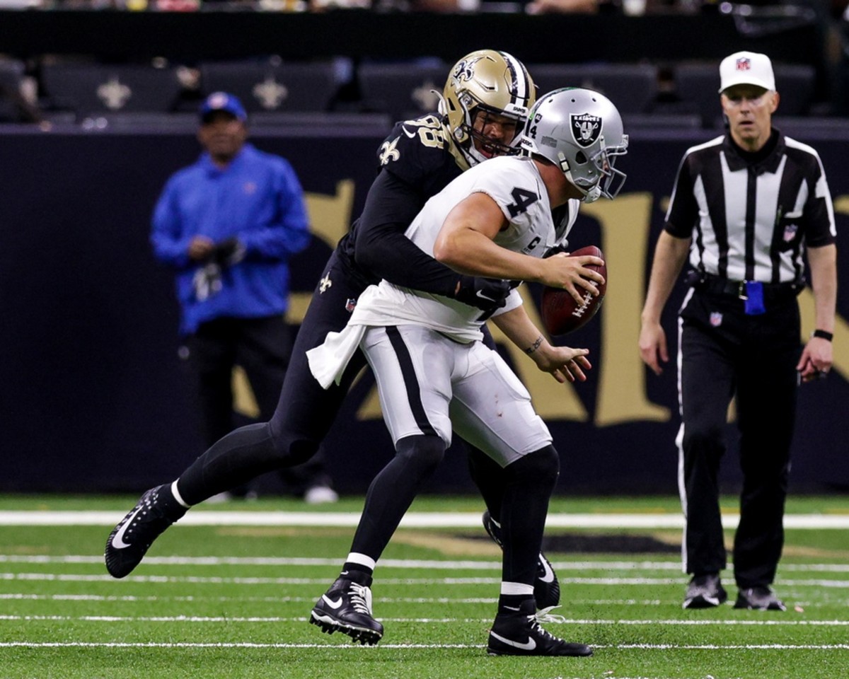 Oct 30, 2022; Las Vegas Raiders quarterback Derek Carr (4) is sacked by New Orleans Saints defensive end Payton Turner (98). Mandatory Credit: Stephen Lew-USA TODAY Sports