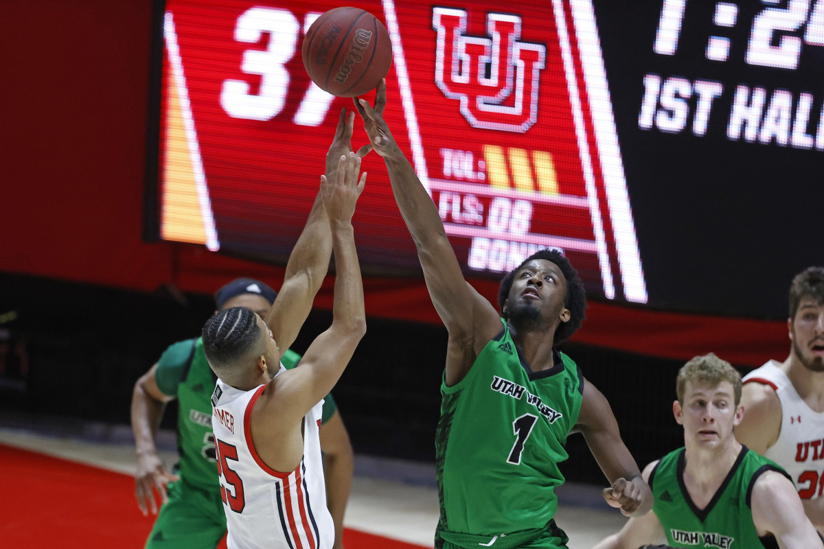 Dec 15, 2020; Salt Lake City, Utah, USA; Utah Valley Wolverines guard Le'Tre Darthard (1) blocks a shot by Utah Utes guard Alfonso Plummer (25) in the first half at the Jon M. Huntsman Center. Mandatory Credit: Jeffrey Swinger-USA TODAY Sports