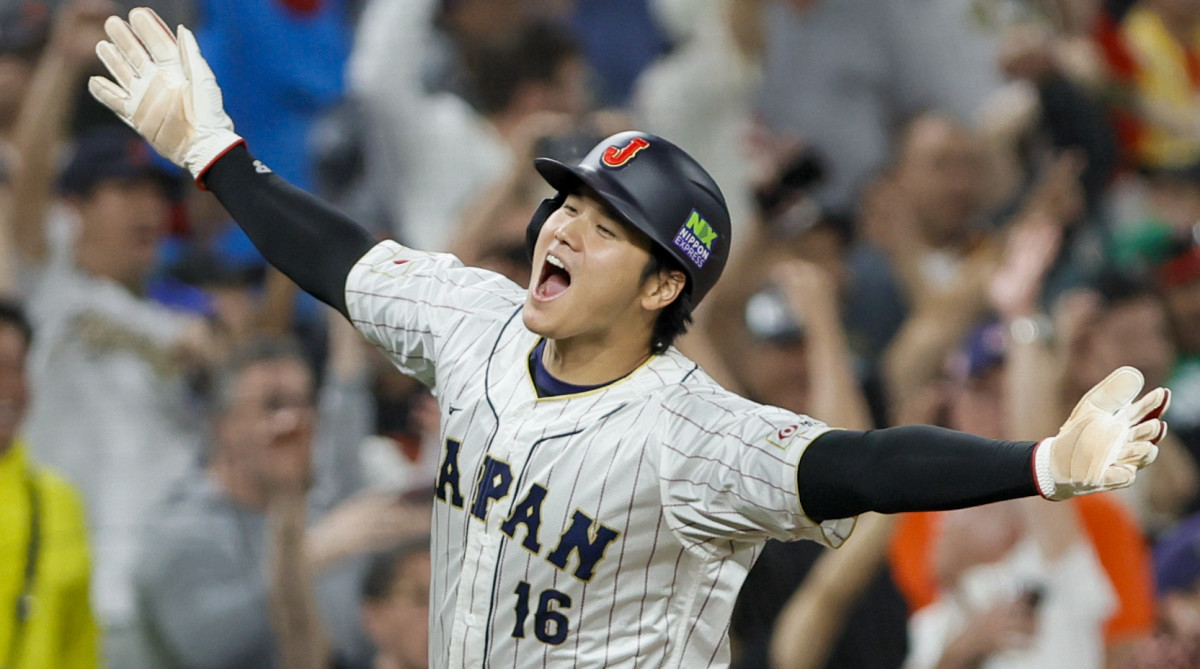 Team Japan DH Shohei Ohtani celebrates with his arms wide while rounding the bases after scoring on a teammate’s three-run homer during the WBC semifinals against Mexico