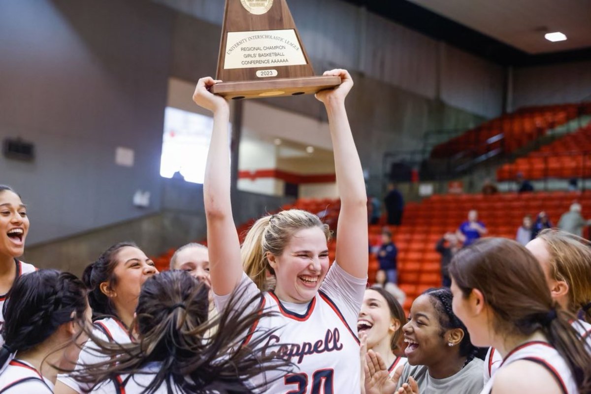 Julianna LaMendola hoists up the University Interscholastic League regional champions trophy for 6A high school girls' basketball.