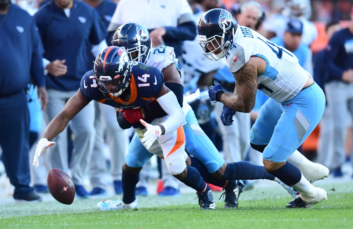Denver wide receiver Courtland Sutton (14) attempts to recover his fumble away from Tennessee cornerback Logan Ryan (26) and linebacker Kamalei Correa (44). (Ron Chenoy-USA TODAY Sports)