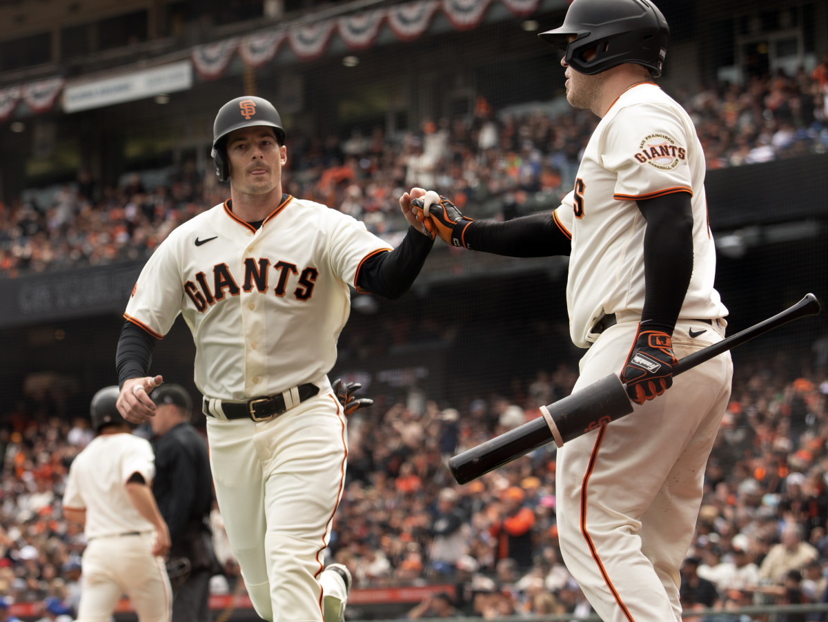 SF Giants center fielder Mike Yastrzemski (left) gets a fist bump from teammate Roberto Perez. (2023)
