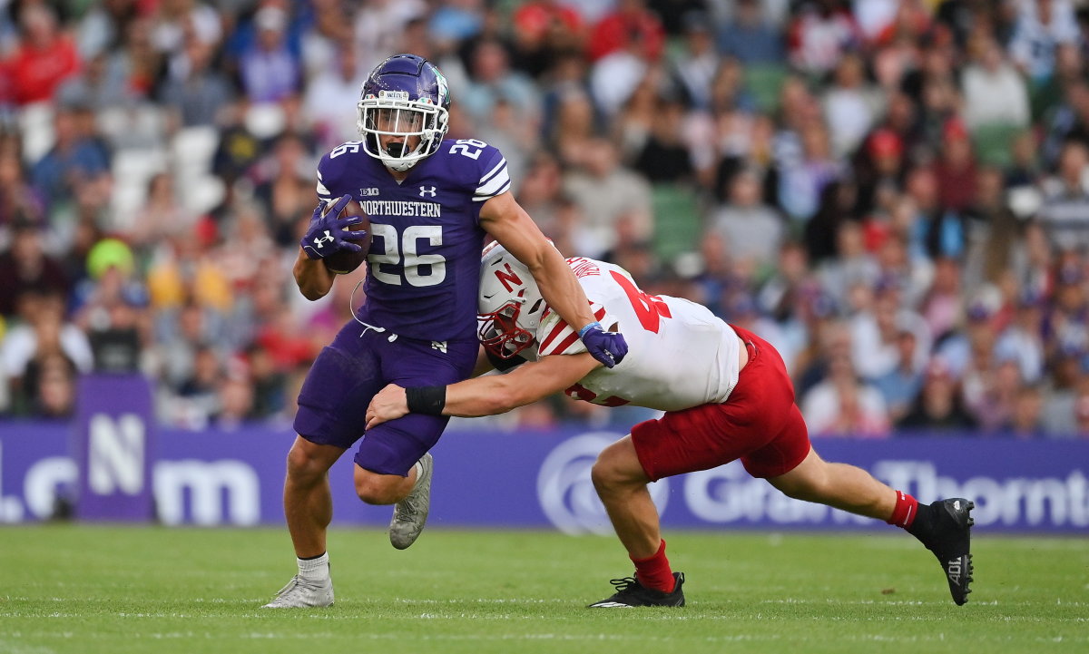 Aug 27, 2022; Dublin, IRELAND; Northwestern Wildcats running back Evan Hull is tackled by Nebraska Cornhuskers linebacker Nick Henrich in the Aer Lingus college football series at Aviva Stadium. Mandatory Credit: Brendan Moran-USA TODAY Sports