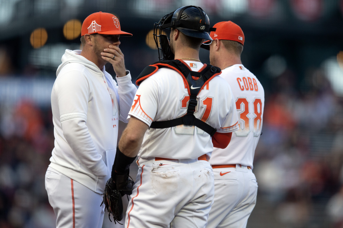 SF Giants pitching coach Andrew Bailey (left) confers with catcher Joey Bart (21) and starting pitcher Alex Cobb (38) during the second inning at Oracle Park on May 16, 2023.