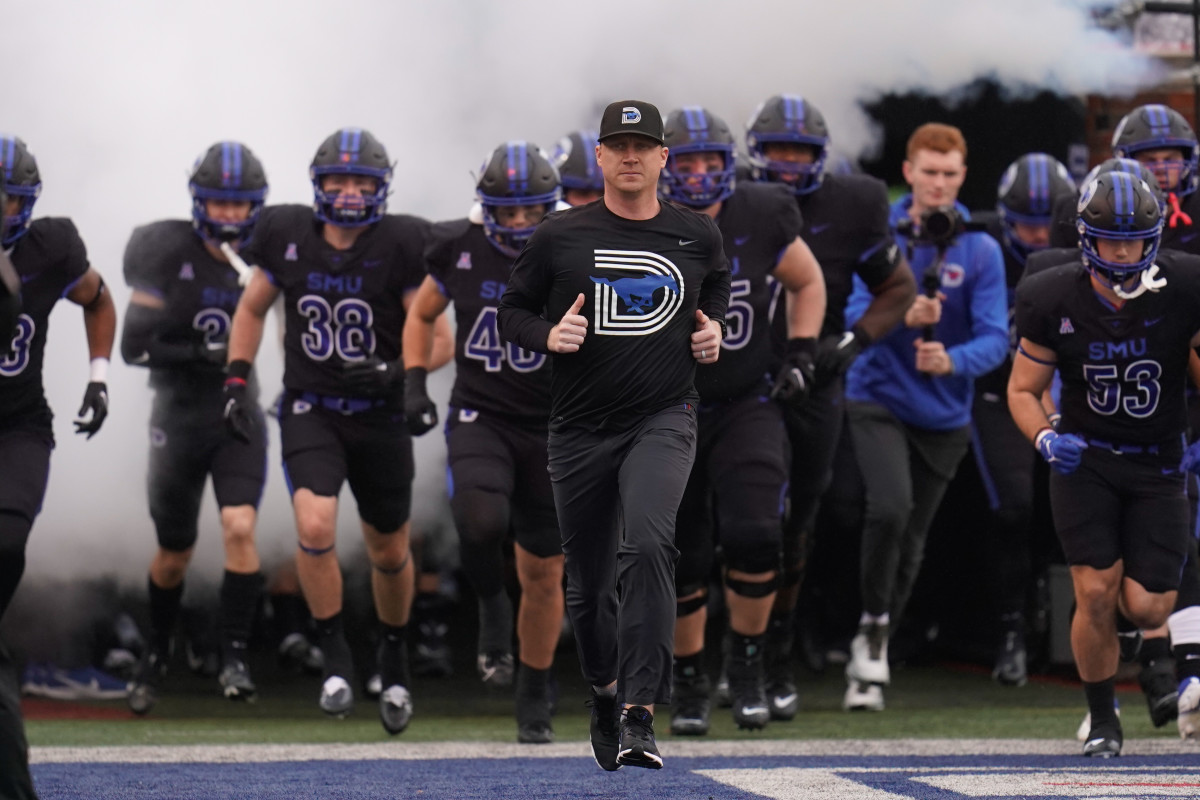 Nov 26, 2022; Dallas, Texas, USA; Southern Methodist Mustangs head coach Rhett Lashlee and the SMU Mustans take the field during the first half against the Memphis Tigers at Gerald J. Ford Stadium. Mandatory Credit: Chris Jones-USA TODAY Sports