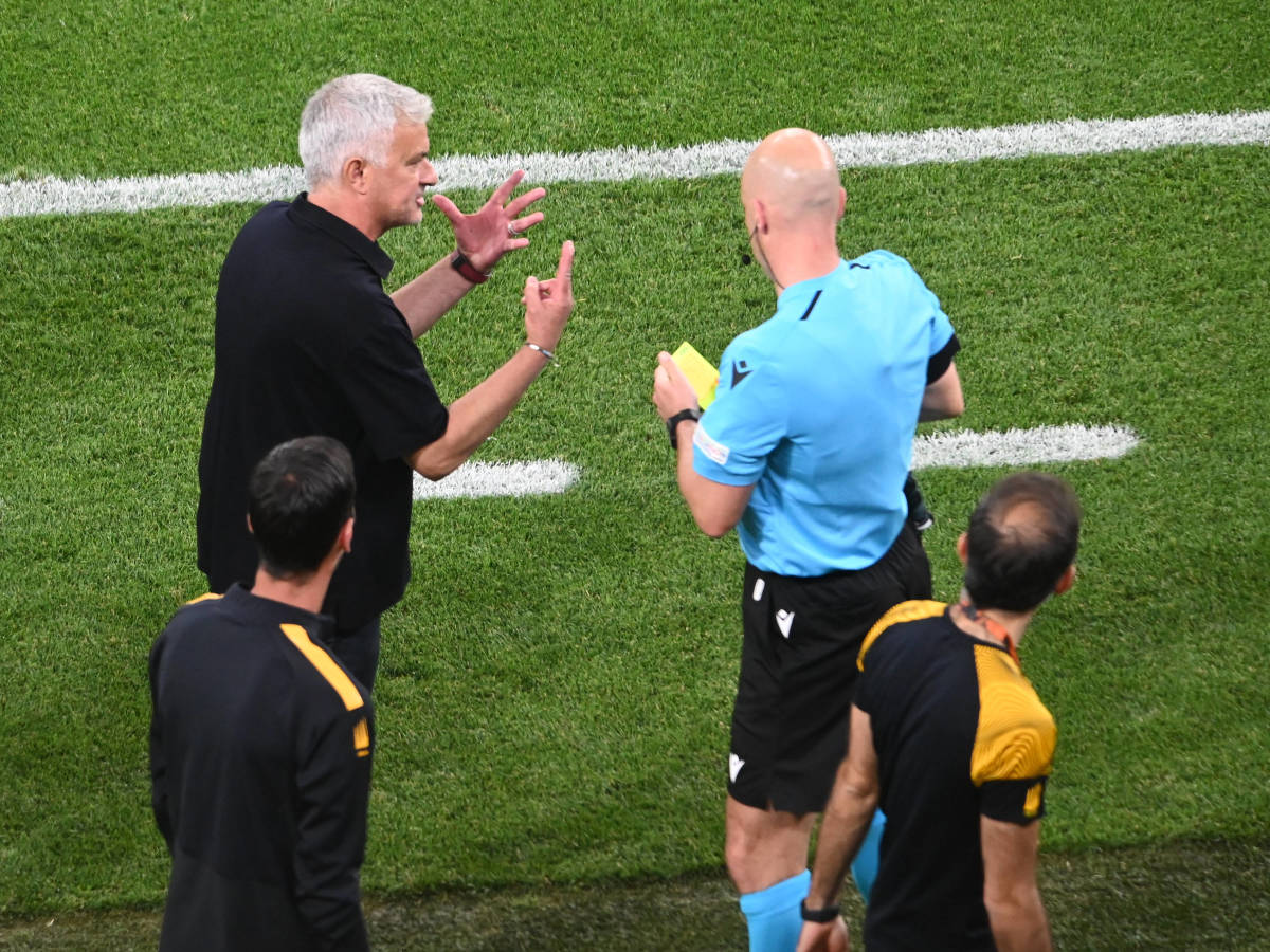 Jose Mourinho pictured (left) gesturing to referee Anthony Taylor during the 2023 Europa League final after the Roma manager had been shown a yellow card