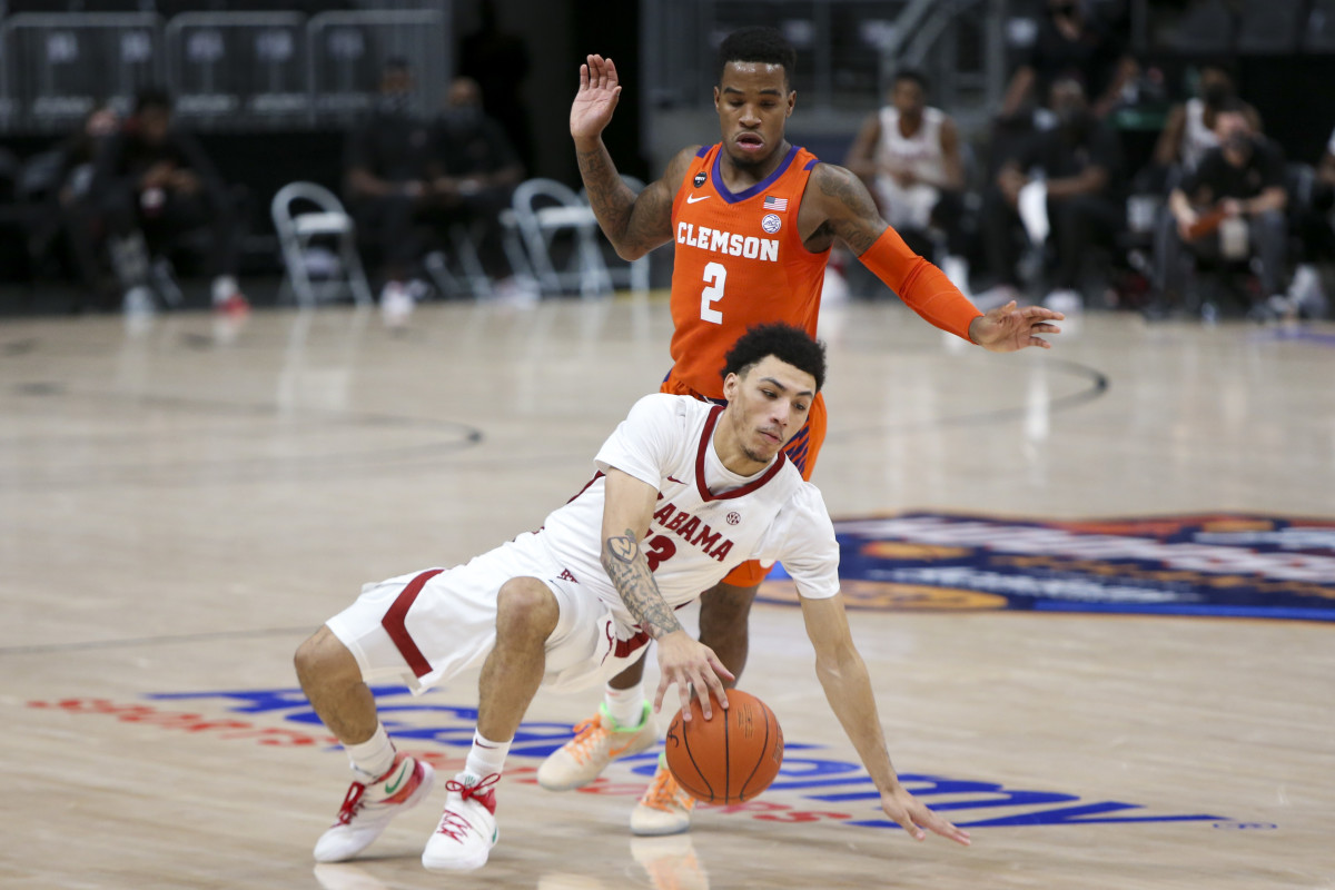 Dec 12, 2020; Atlanta, Georgia, USA; Alabama Crimson Tide guard Jahvon Quinerly (13) dribbles defended by Clemson Tigers guard Al-Amir Dawes (2) in the first half of a Holiday Hoopsgiving game at State Farm Arena. Mandatory Credit: Brett Davis-USA TODAY Sports