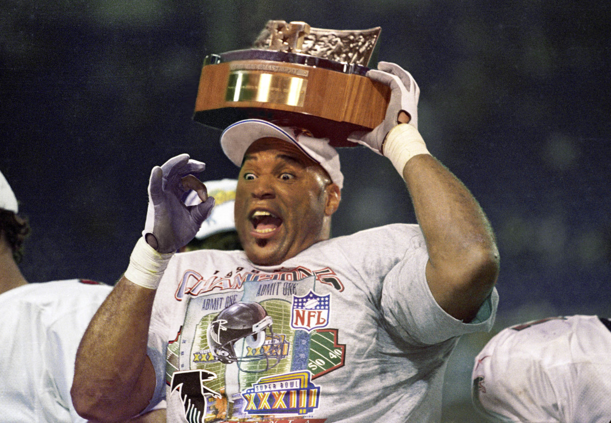 Atlanta Falcons linebacker Cornelius Bennett holds the Halas Trophy after defeating the Minnesota Vikings in the 1998 NFC Championship Game at the Metrodome. The Falcons defeated the Vikings 30-27.