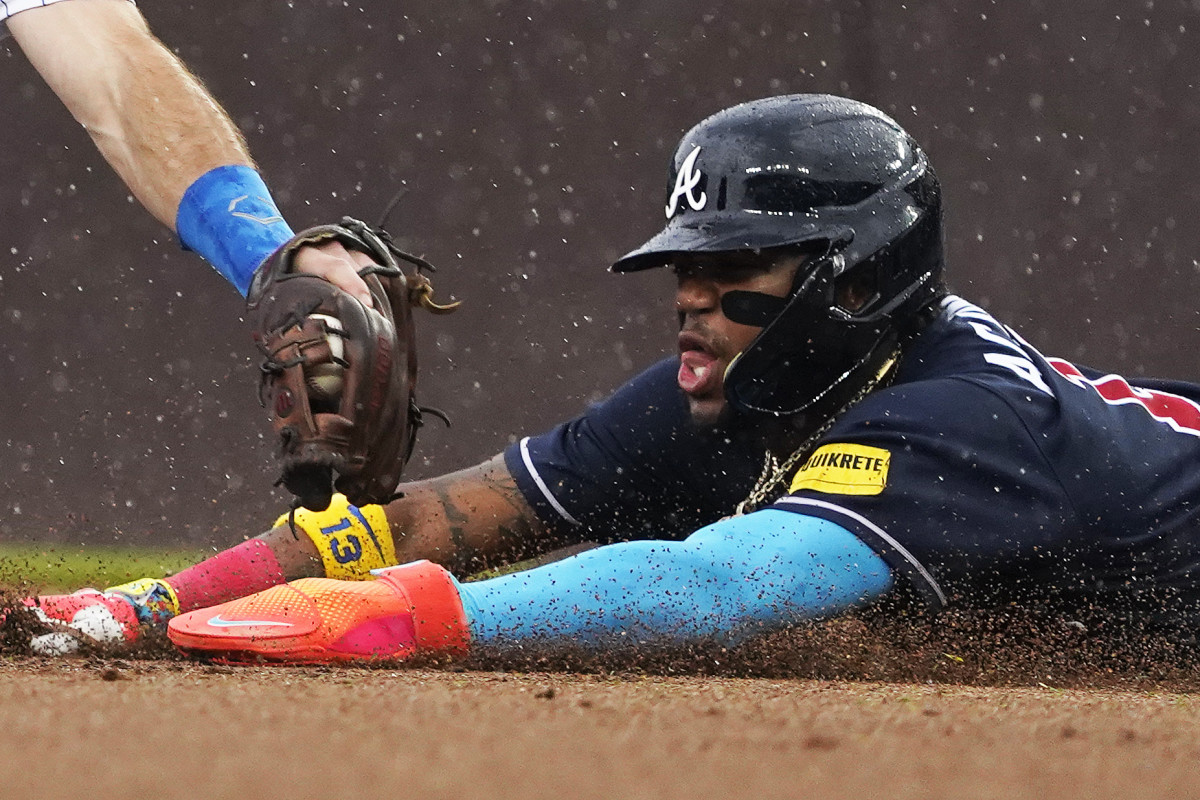 Aug 5, 2023; Chicago, Illinois, USA; Atlanta Braves right fielder Ronald Acuna Jr. (13) steals second base as Chicago Cubs shortstop Dansby Swanson (7) makes a late tag during the first inning at Wrigley Field.