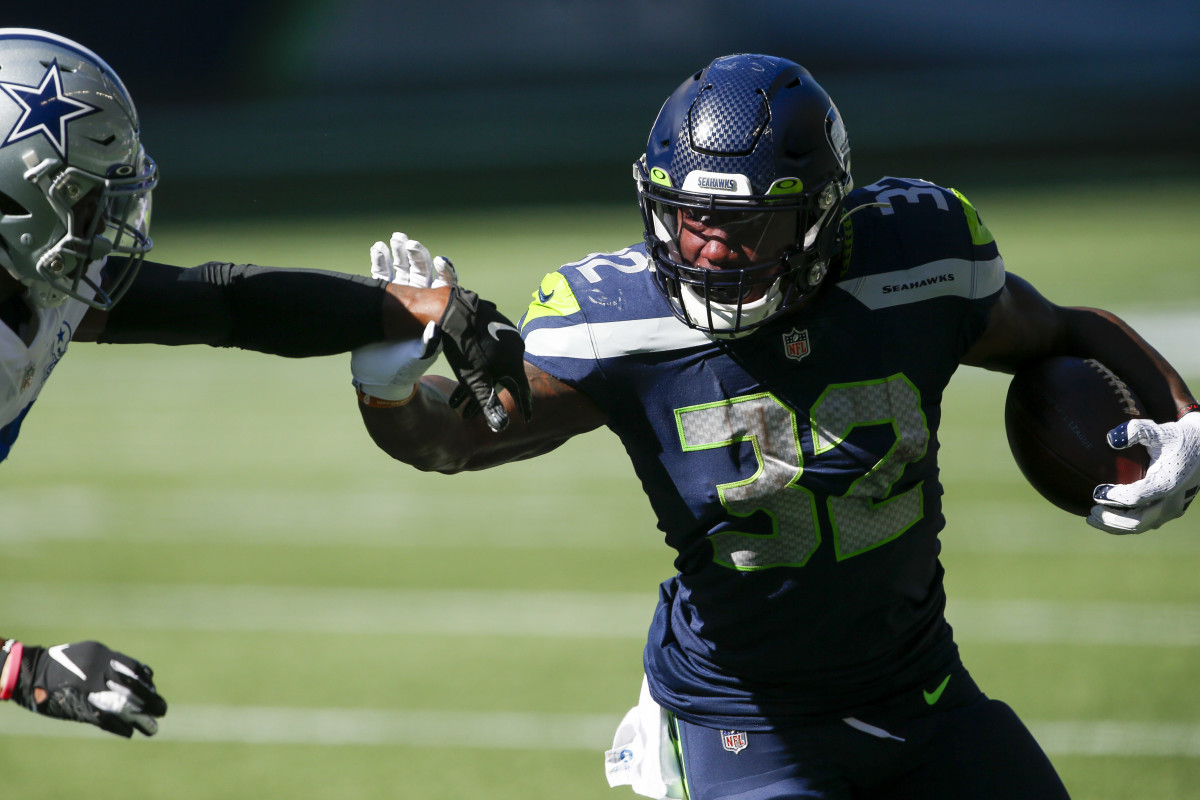 Seattle Seahawks running back Chris Carson (32) rushes against the Dallas Cowboys during the second quarter at CenturyLink Field.