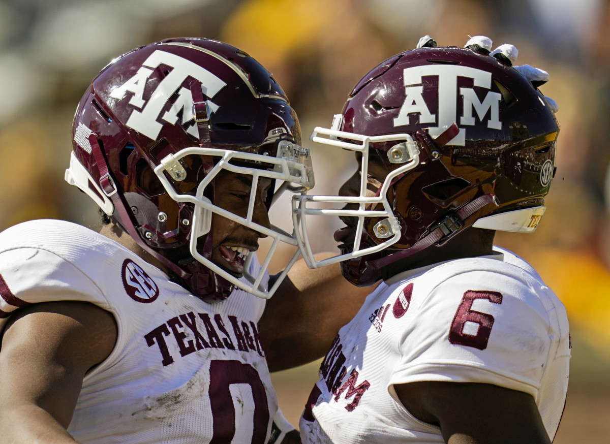 Oct 16, 2021; Columbia, Missouri, USA; Texas A&M Aggies running back Devon Achane (6) celebrates with wide receiver Ainias Smith (0) after scoring a touchdown against the Missouri Tigers during the second half at Faurot Field at Memorial Stadium. Mandatory Credit: Jay Biggerstaff-USA TODAY Sports