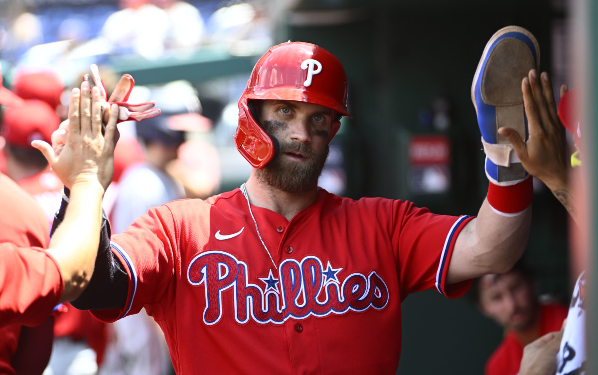 Bryce Harper celebrates with teammates after scoring a run against the Washington Nationals.