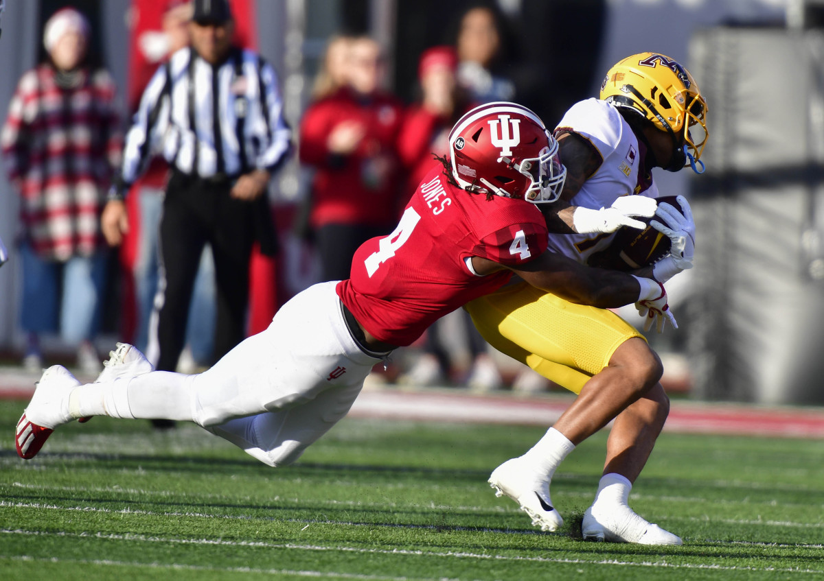 Cam Jones tackles Minnesota Golden Gophers wide receiver Chris Autman-Bell during the first quarter at Memorial Stadium.