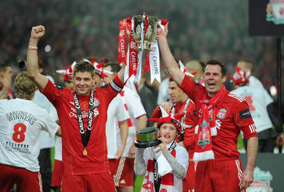 Steven Gerrard and Jamie Carragher pictured holding the League Cup trophy after Liverpool won it in 2012