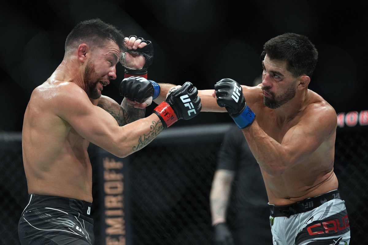 Pedro Munhoz defends against Dominick Cruz during UFC 269 at T-Mobile Arena.