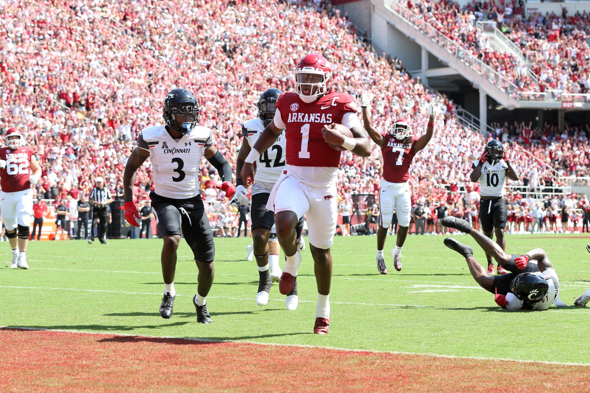 Sep 3, 2022; Fayetteville, Arkansas, USA; Arkansas Razorbacks quarterback KJ Jefferson (1) rushes for a touchdown in the first quarter as Cincinnati Bearcats safety Ja von Hicks (3) defends at Donald W. Reynolds Razorback Stadium. Mandatory Credit: Nelson Chenault-USA TODAY Sports
