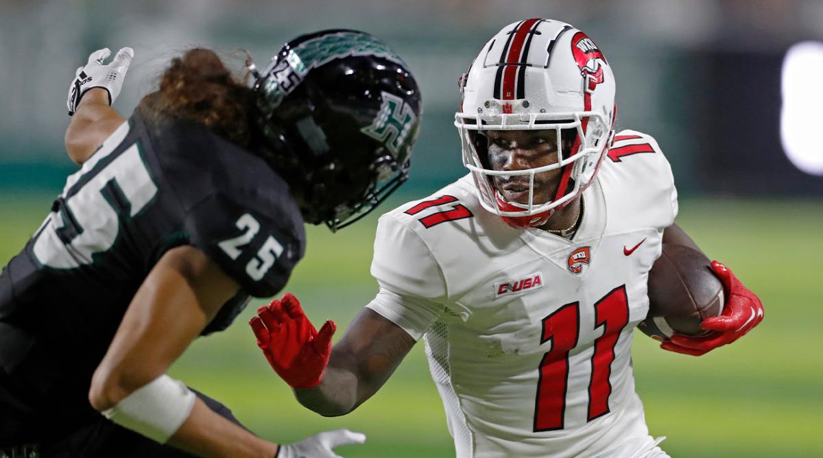 Western Kentucky wide receiver Malachi Corley (11) prepares to fend off Hawaii defensive back Matagi Thompson (25) during the first half of an NCAA college football game Saturday, Sept. 3, 2022, in Honolulu.