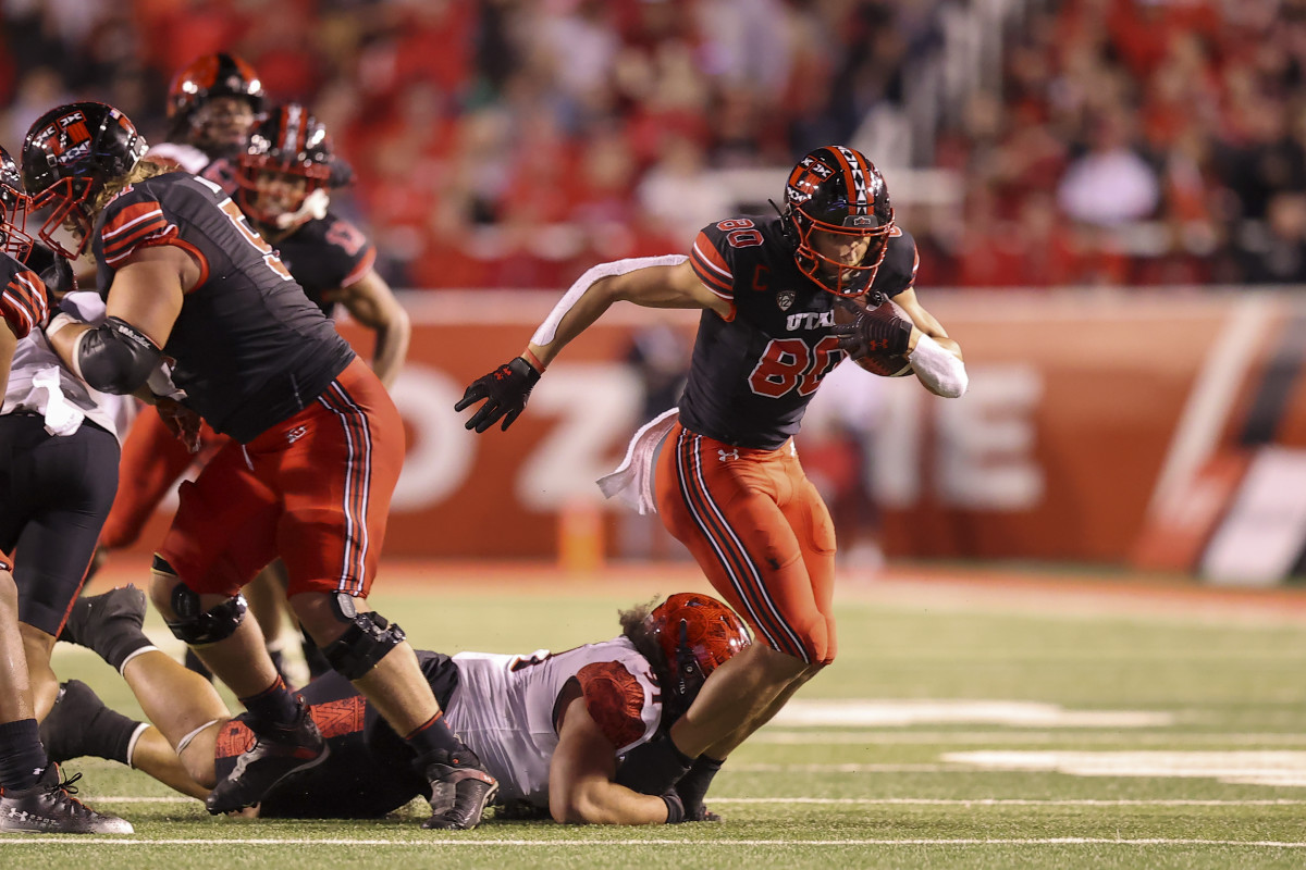 Utah Utes tight end Brant Kuithe (80) catches a pass and is brought down by San Diego State Aztecs defensive lineman Justus Tavai (91) in the second quarter at Rice-Eccles Stadium.