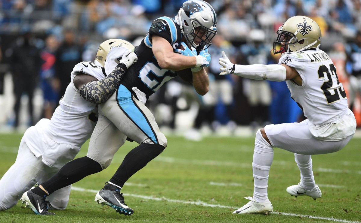 Carolina Panthers running back Christian McCaffrey (22) is tackled by New Orleans Saints linebacker Demario Davis (56) and cornerback Marshon Lattimore (23). Mandatory Credit: Bob Donnan-USA TODAY