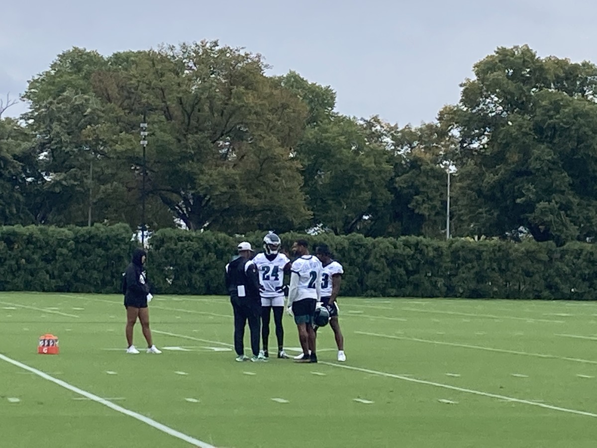 James Bradberry (24), Darius Slay (2), and Chauncey Gardner-Johnson (right) talk with DB coach Dennard Wilson during practice on Sept. 22, 2022