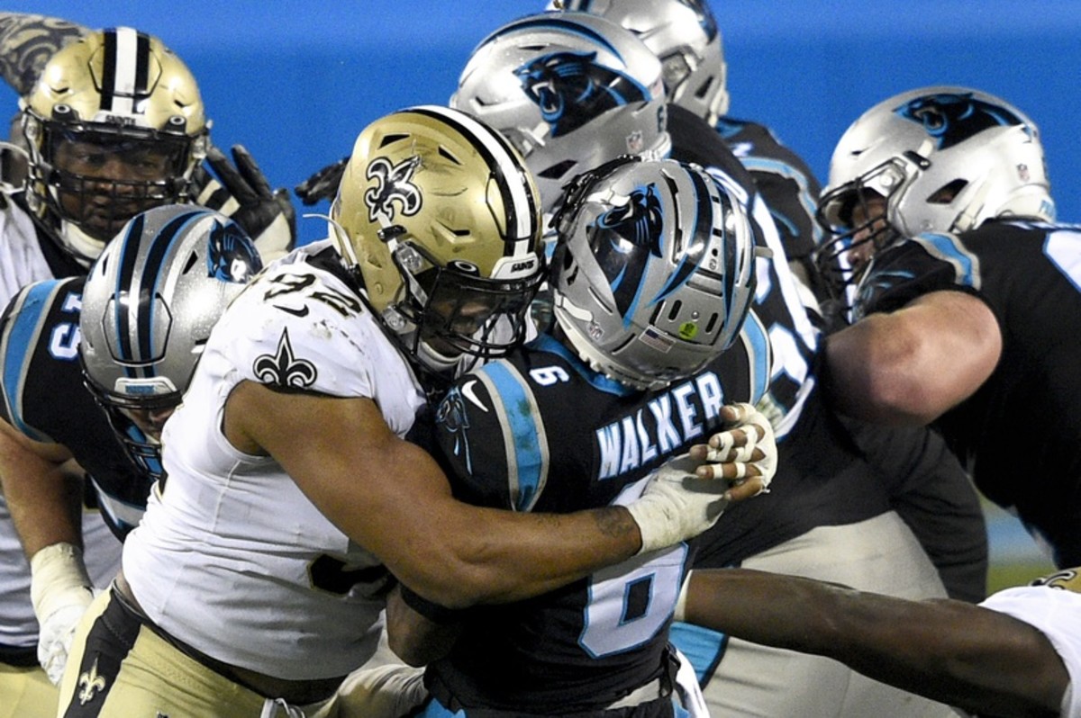 Jan 3, 2021; Carolina Panthers quarterback P.J. Walker (6) throws an interception as he is hit by New Orleans Saints defensive end Marcus Davenport (92). Mandatory Credit: Bob Donnan-USA TODAY 