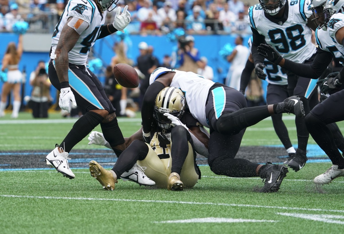New Orleans Saints running back Alvin Kamara (41) fumbles the ball on the hit by Carolina Panthers defensive tackle Daviyon Nixon (54). Mandatory Credit: James Guillory-USA TODAY Sports