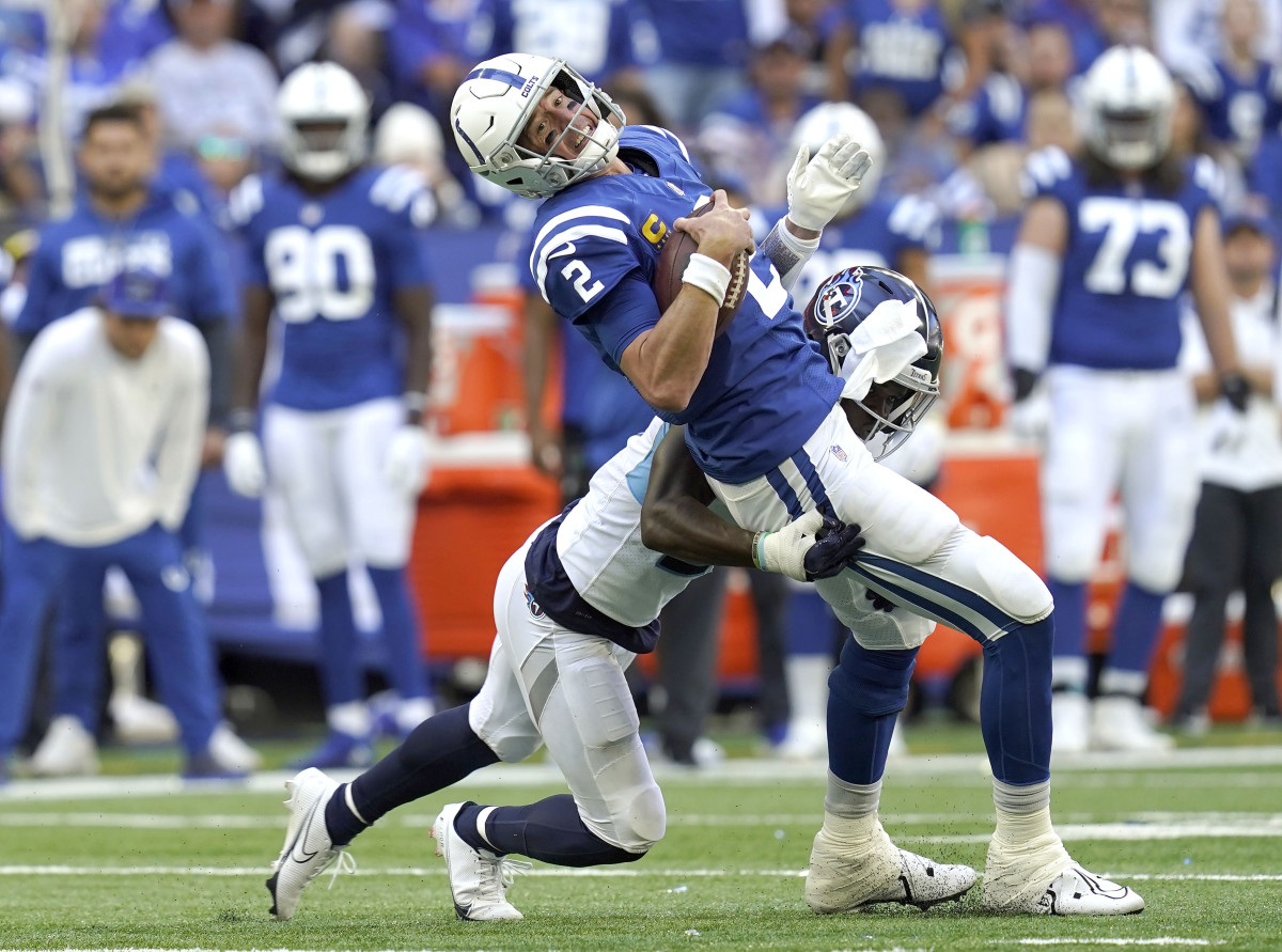 Oct 2, 2022; Indianapolis, Indiana, USA; Tennessee Titans cornerback Roger McCreary (21) tackles Indianapolis Colts quarterback Matt Ryan (2) during the first half at Lucas Oil Stadium. Mandatory Credit: Armond Feffer/IndyStar-USA TODAY NETWORK