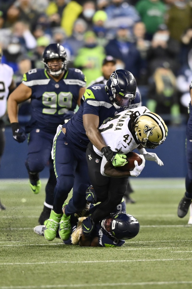Former Seattle Seahawks defensive end Carlos Dunlap (8) and safety Quandre Diggs (6) tackle New Orleans Saints running back Alvin Kamara (41). Mandatory Credit: Steven Bisig-USA TODAY Sports