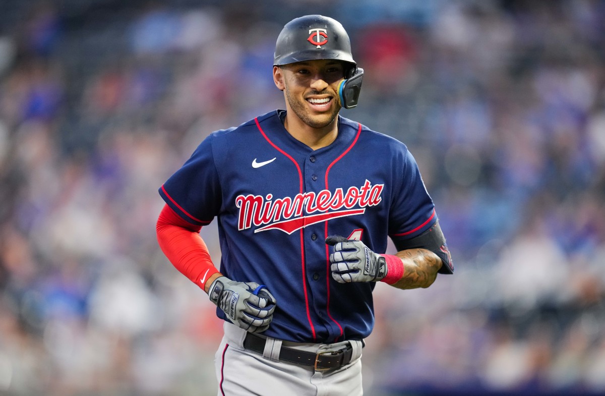 Twins shortstop Carlos Correa smiles as he jogs to the dugout. (2022)