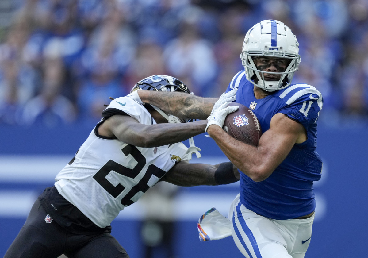Oct 16, 2022; Indianapolis, Indiana, USA; Indianapolis Colts wide receiver Michael Pittman Jr. (11) pushes off of Jacksonville Jaguars cornerback Shaquill Griffin (26) as he runs with the ball during the first half at Lucas Oil Stadium.