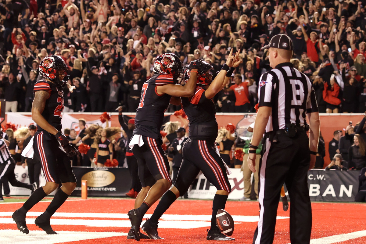 Utah Utes quarterback Cameron Rising (7) celebrates scoring a two-point conversation to take a one point lead against the USC Trojans in the final minute of the game at Rice-Eccles Stadium.