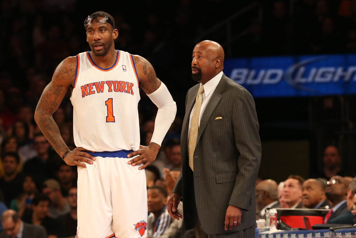 Feb 24, 2013; New York, NY, USA; New York Knicks head coach Mike Woodson talks with power forward Amar'e Stoudemire (1) during the first quarter against the Philadelphia 76ers at Madison Square Garden.