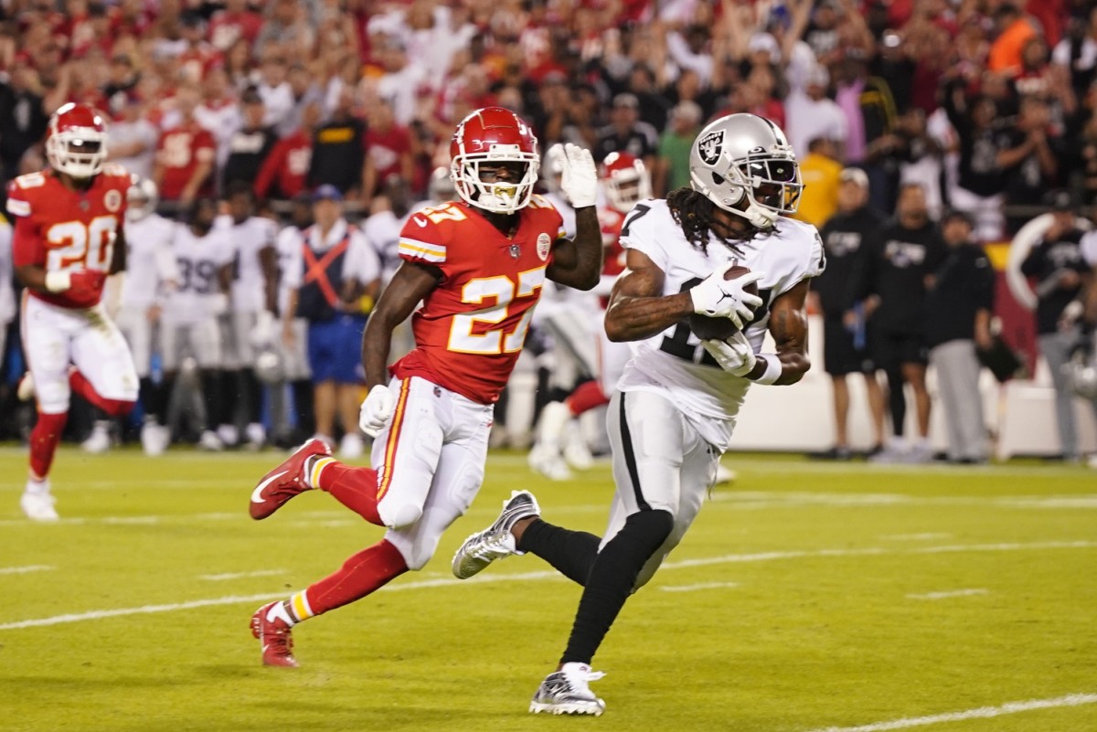 Las Vegas Raiders receiver Davante Adams (17) runs the ball in for a touchdown pursued by Kansas City Chiefs cornerback Rashad Fenton (27). Mandatory Credit: Jay Biggerstaff-USA TODAY Sports