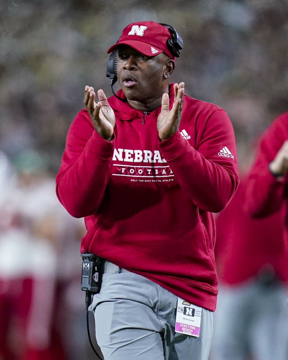 Mickey Joseph coaches along the sidelines for Nebraska.