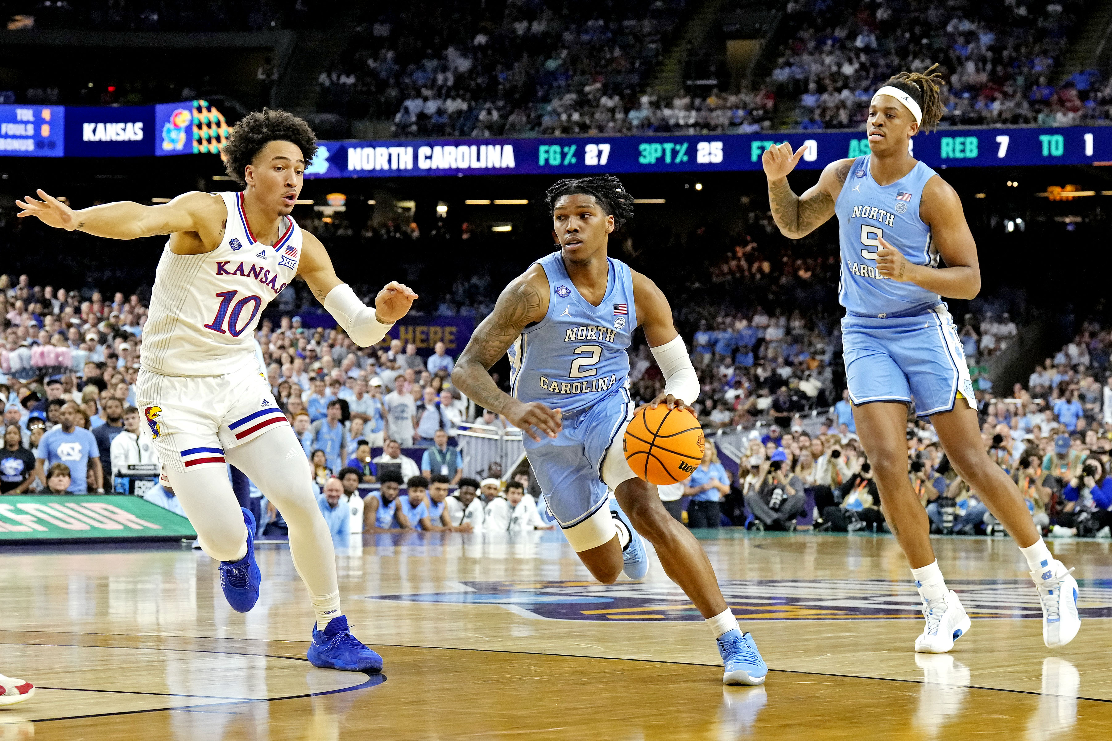 #2 Caleb Love drives to the basket in the 2022 NCAA Championship game