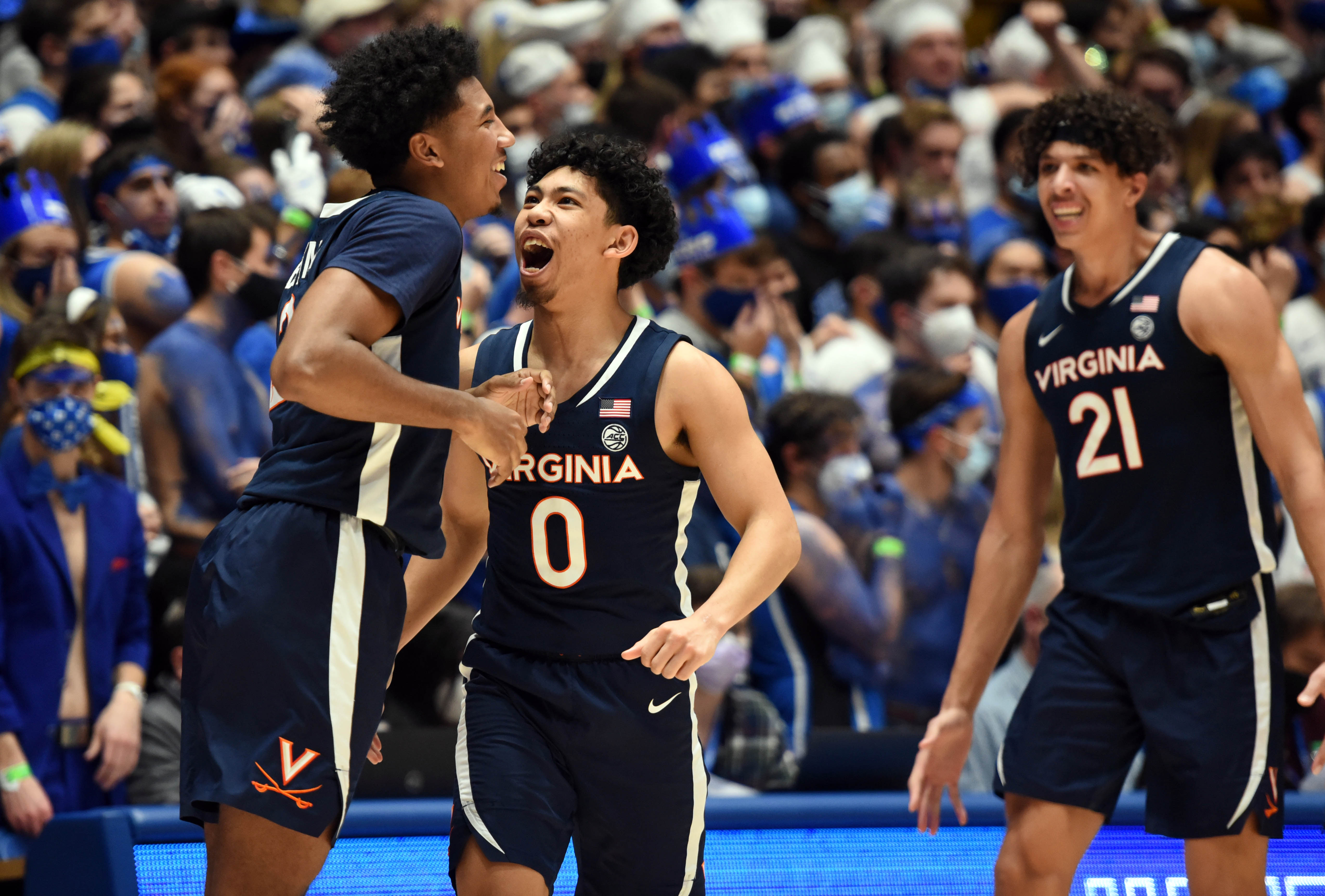 #0 Kihei Clark celebrates with teammates #2 Reece Beekman and #21 Kadin Shedrick 