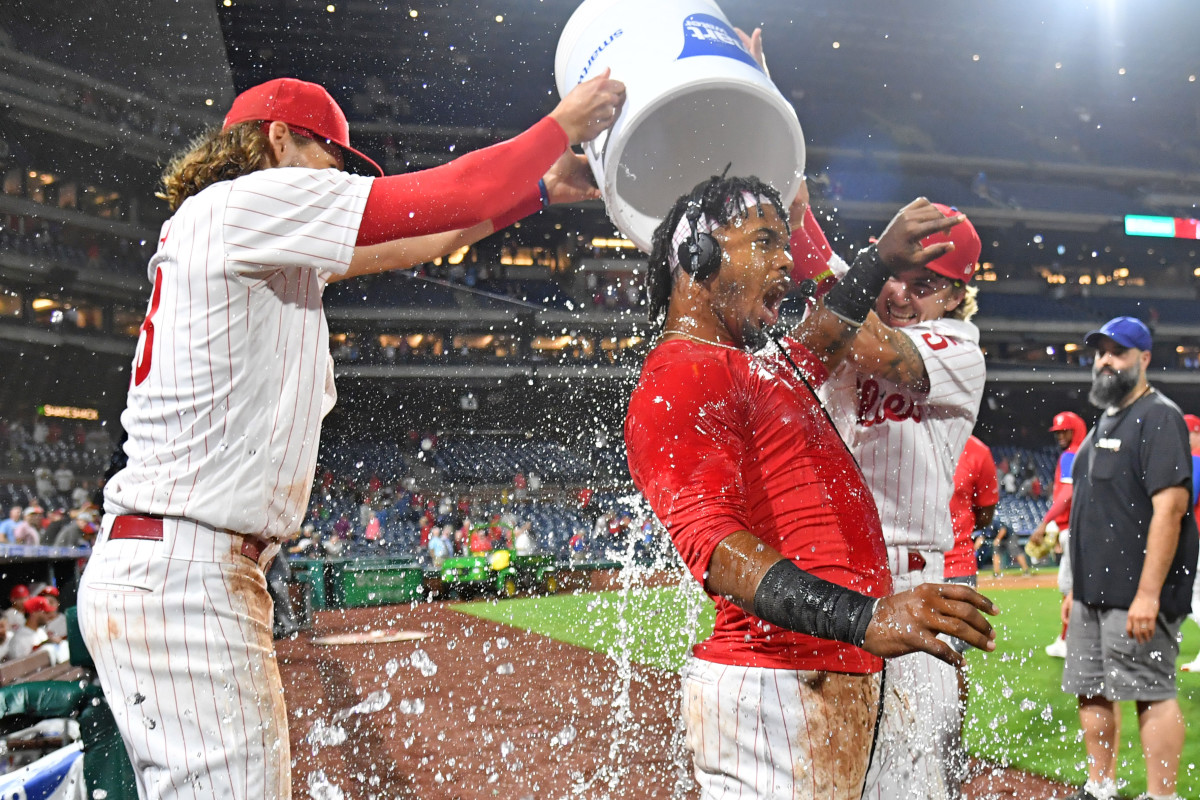 Alec Bohm and Bryson Stott help Jean Segura celebrate a walk-off single. 