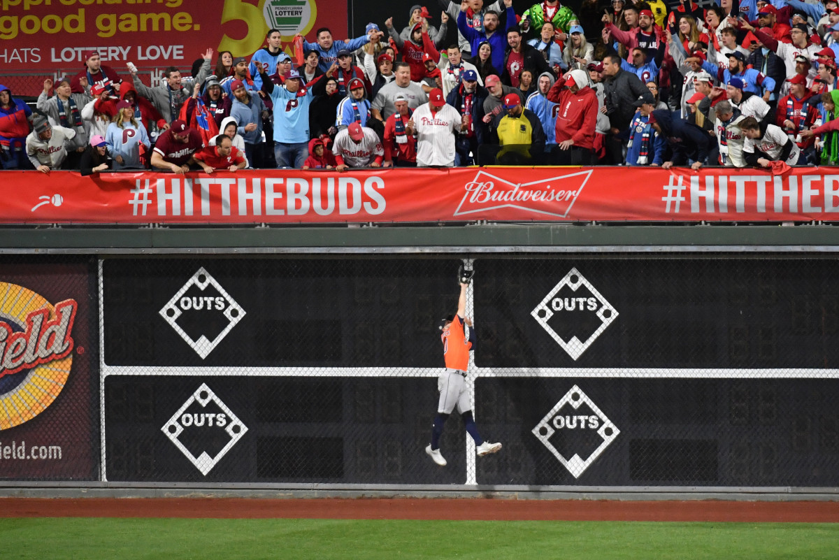 Astros player Chas McCormick jumps to make a catch