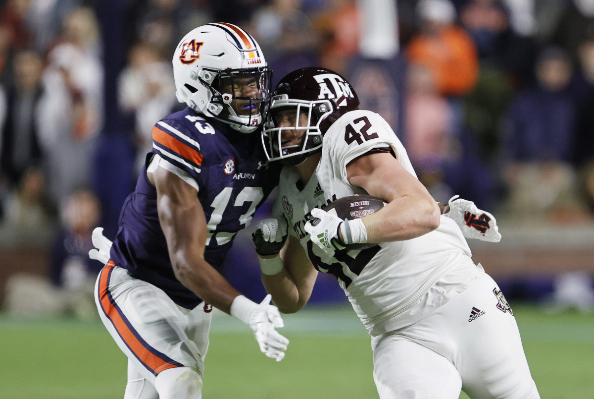 Nov 12, 2022; Auburn, Alabama, USA; Texas A&M Aggies tight end Max Wright (42) is tackled by Auburn Tigers linebacker Cam Riley (13) during the second quarter at Jordan-Hare stadium. Mandatory Credit: John Reed-USA TODAY Sports