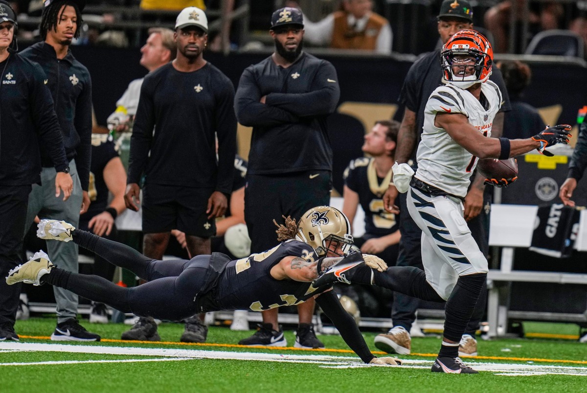 Cincinnati Bengals wide receiver Ja'Marr Chase (1) breaks a tackle by New Orleans Saints safety Tyrann Mathieu (32) to score a touchdown late in the fourth quarter. © Cara Owsley/The Enquirer / USA TODAY NETWORK