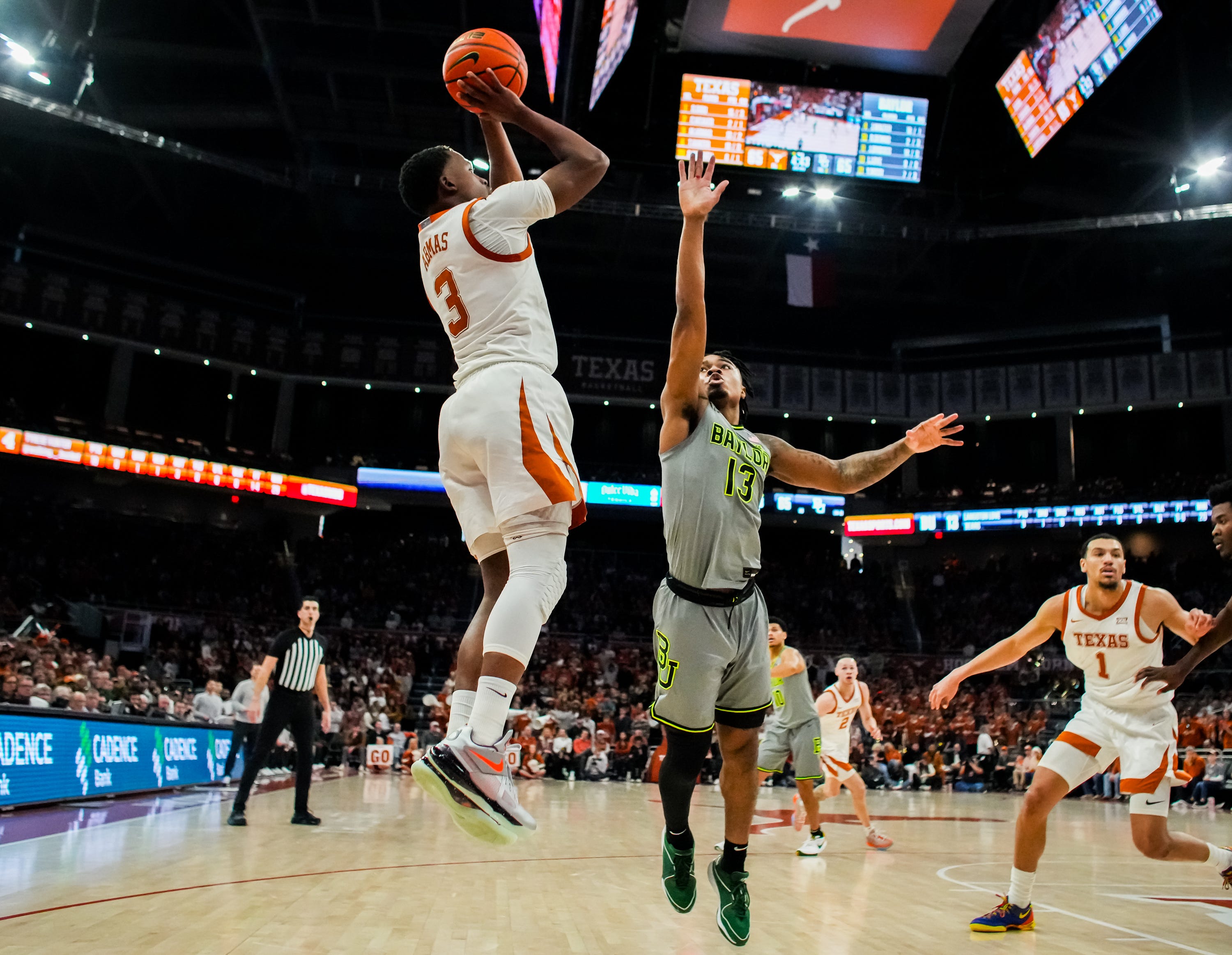Texas Longhorns guard Max Abmas (3) shoots the ball over defense from Baylor Bears guard Langston Love (13) in the second half of the Longhorns' game against the Baylor Bears at the Moody Center in Austin, Jan 20, 2024. Texas won the game 75-73 with a layup in the final seconds of the game.