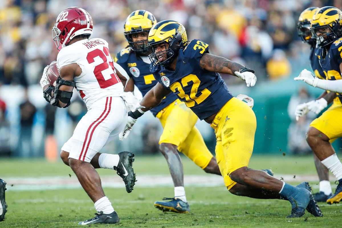 Michigan defensive end Jaylen Harrell (32) looks to tackle Alabama running back Justice Haynes.