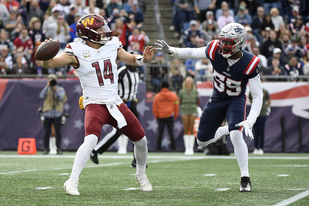 Nov 5, 2023; Foxborough, Massachusetts, USA; Washington Commanders quarterback Sam Howell (14) gets set to throw a pass while New England Patriots linebacker Josh Uche (55) defends during the first half at Gillette Stadium. 